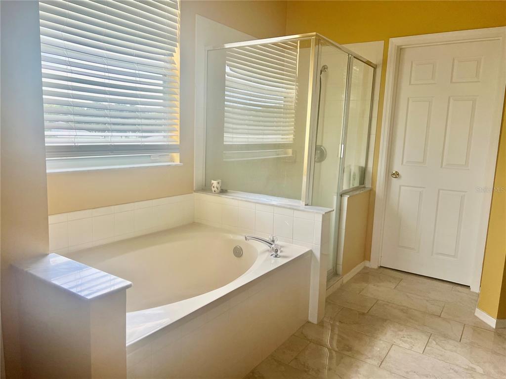 13315 Daffodil Way Astatula, FL 34705 - Photo 19 of 29 a bathroom with a bathtub and shower