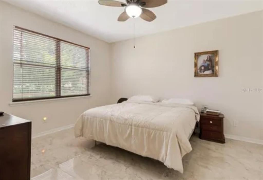 13315 Daffodil Way Astatula, FL 34705 - Photo 22 of 29 a bedroom with a bed and a large window
