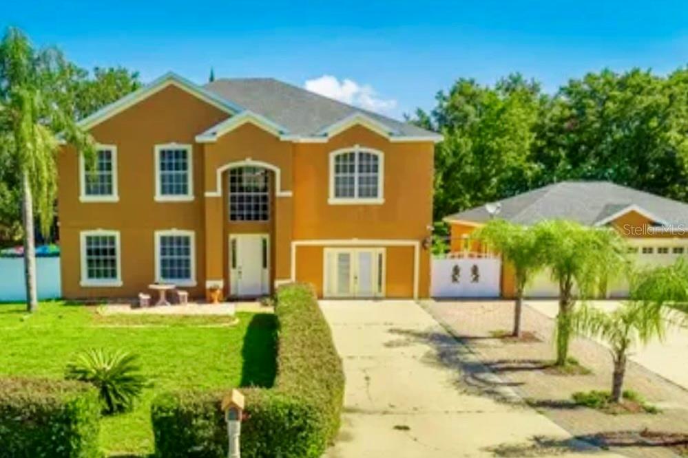 13315 Daffodil Way Astatula, FL 34705 - Photo 29 of 29 a front view of a house with garden