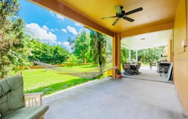 a view of a patio with a table chairs and a backyard