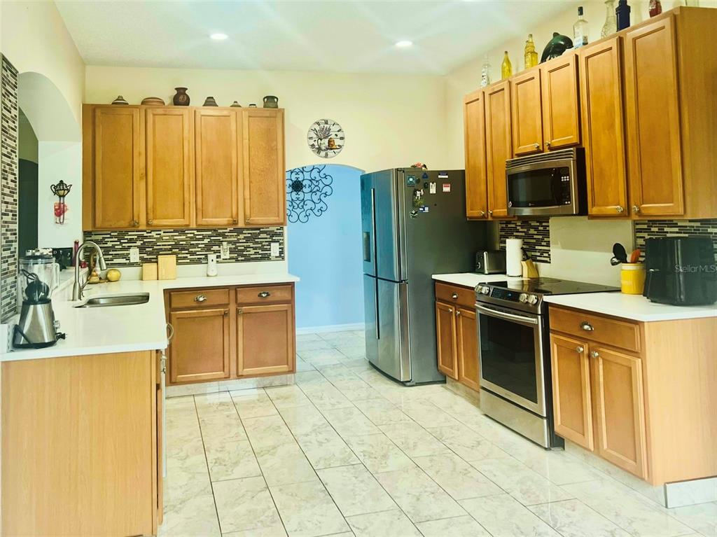 13315 Daffodil Way Astatula, FL 34705 - Photo 8 of 29 a kitchen with a sink appliances and cabinets