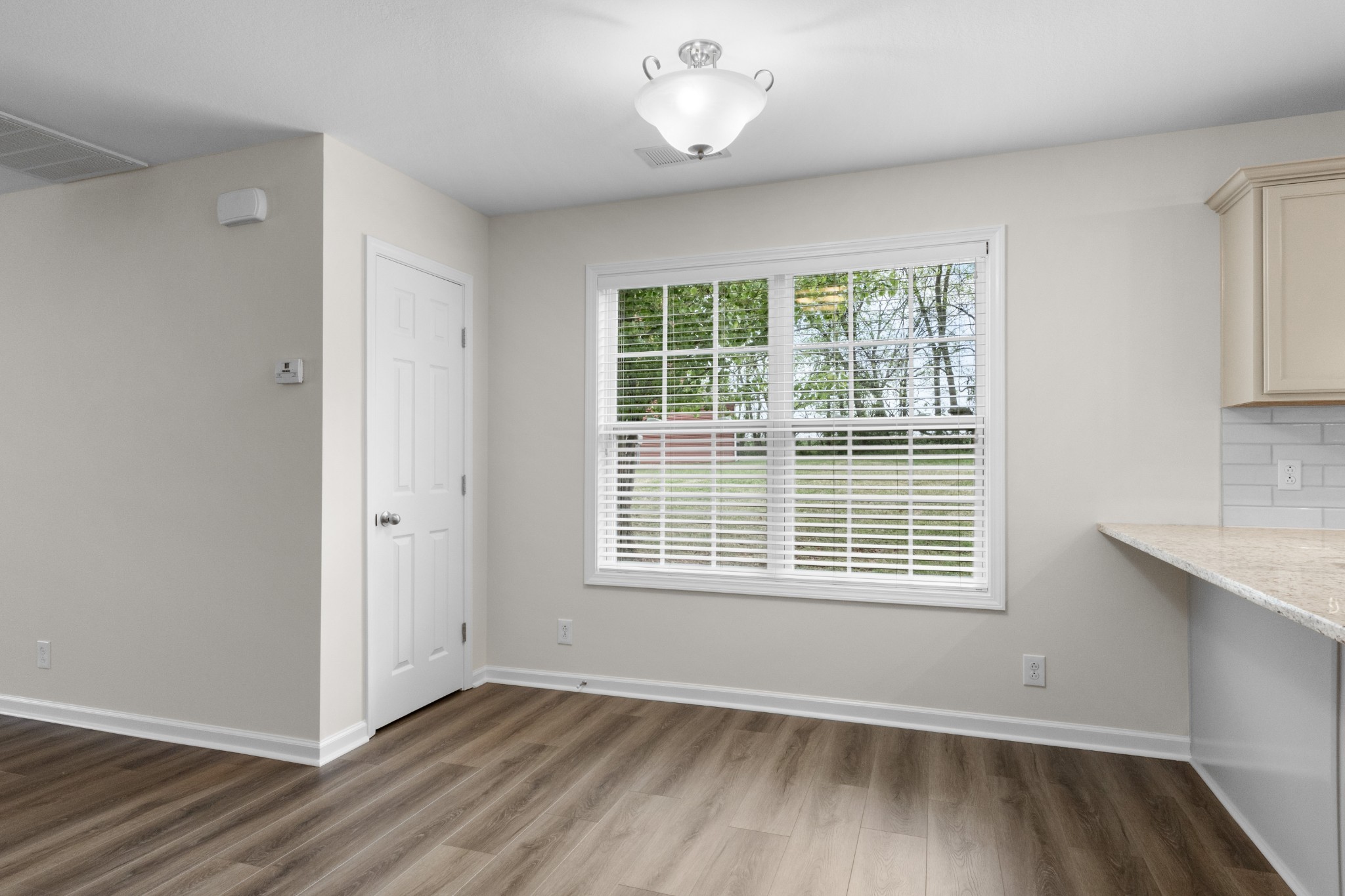 179 Alexander Boulevard Clarksville, TN 37040 - Photo 11 of 40 a view of an empty room with wooden floor and a window