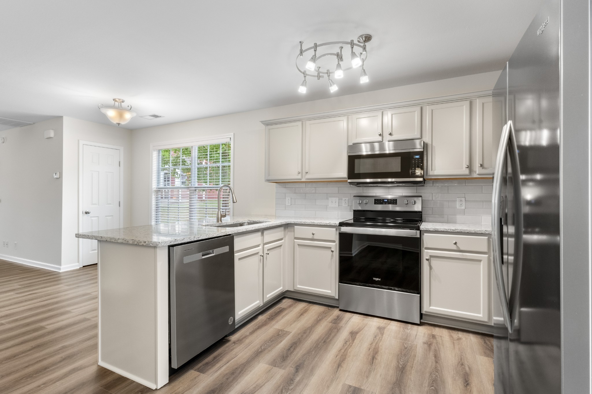 179 Alexander Boulevard Clarksville, TN 37040 - Photo 15 of 40 a kitchen with stainless steel appliances granite countertop a stove top oven a sink and a refrigerator