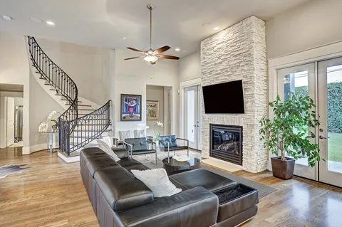 a living room with furniture a fireplace and a flat screen tv