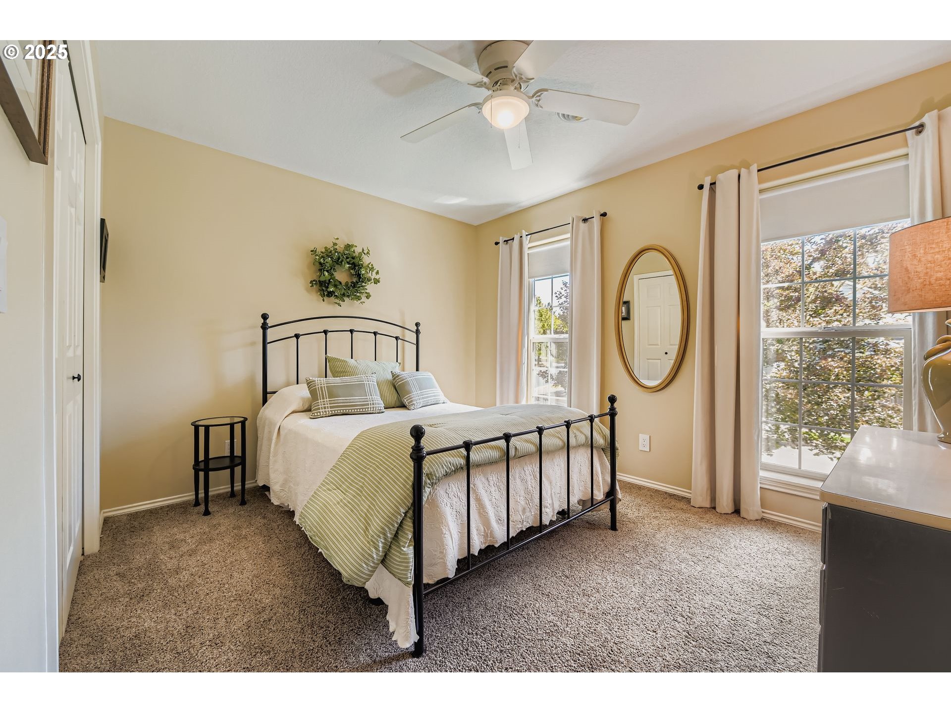 716 Roxe Drive Forest Grove, OR 97116 - Photo 20 of 37 a bedroom with a bed a window and a chandelier