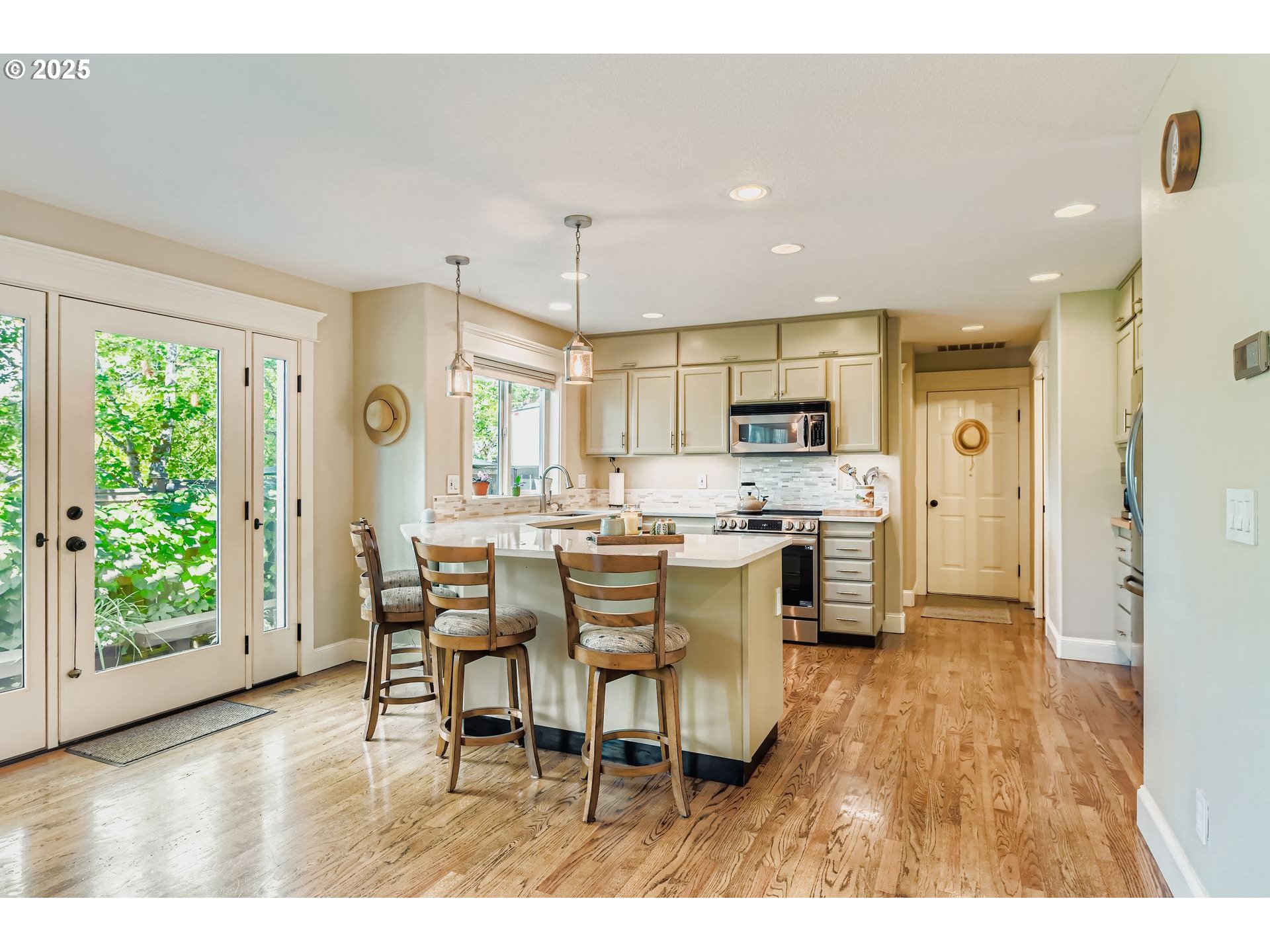 716 Roxe Drive Forest Grove, OR 97116 - Photo 9 of 37 a kitchen with stainless steel appliances kitchen island granite countertop a refrigerator a stove a sink dishwasher with a dining table and chairs