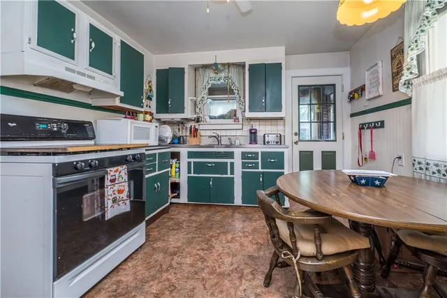 a kitchen with stainless steel appliances granite countertop a stove a sink dishwasher and cabinets