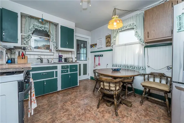 a kitchen with a table and chairs in it