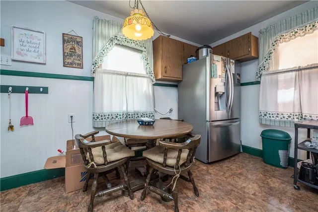 a view of a dining room with furniture and a chandelier