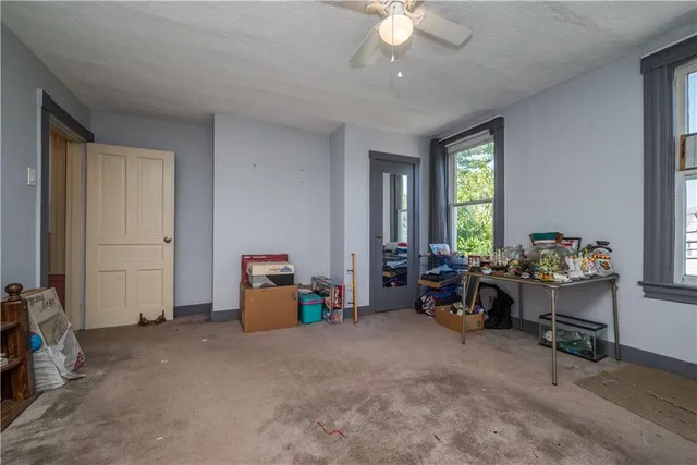 a view of a livingroom with furniture and a window