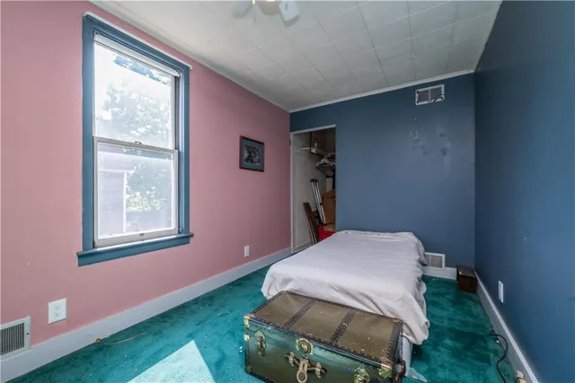 a bedroom with a bed and a window