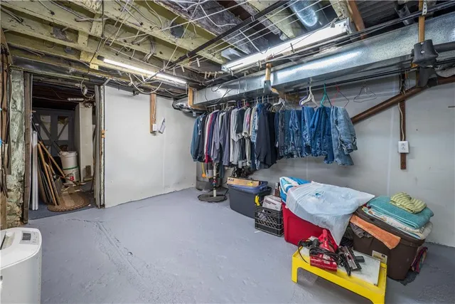 a white toilet sitting next to a bathroom sink and a shower