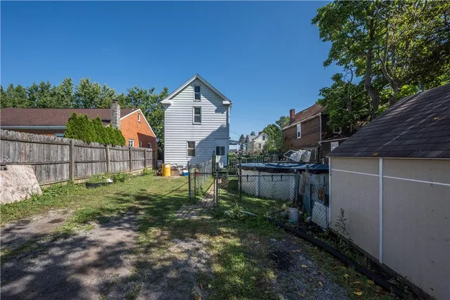 a view of a house with a patio and a yard
