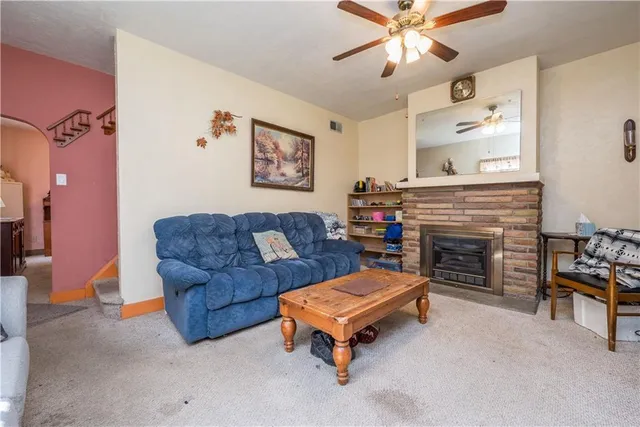 a living room with furniture and a fireplace