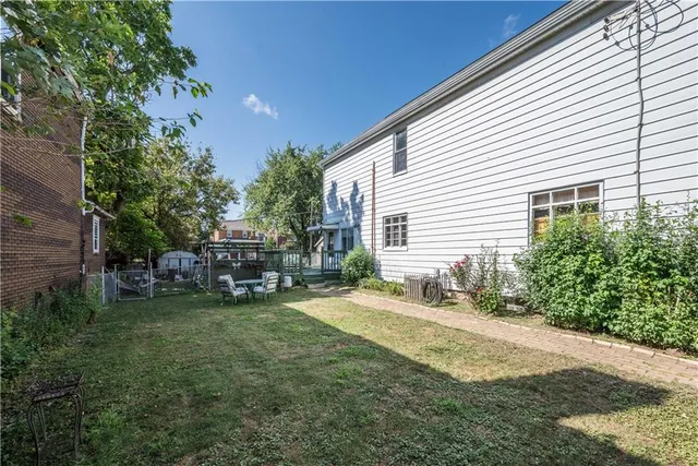 a view of a backyard with barn and large trees
