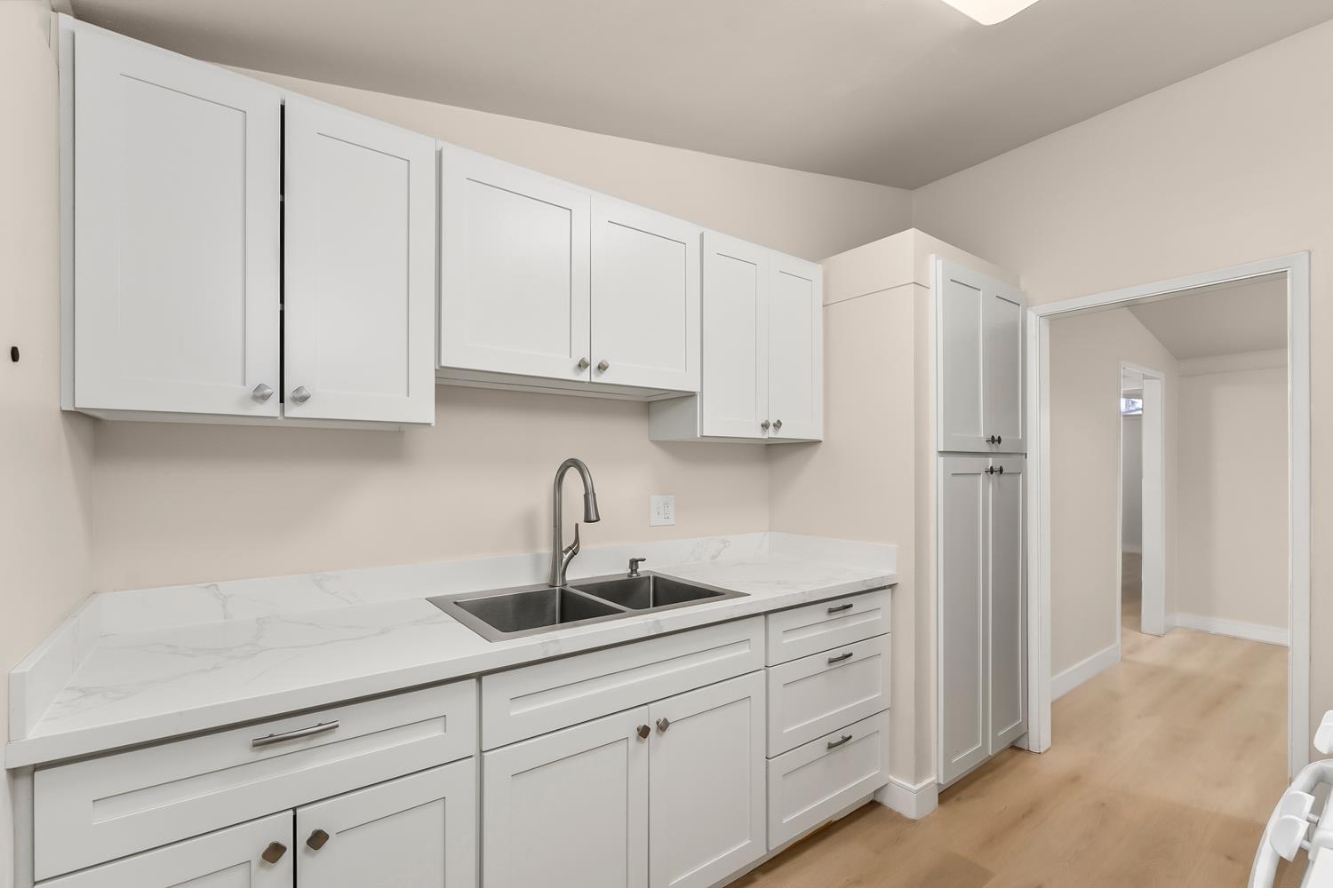 317 Brookwood Road Roseville, CA 95678 - Photo 11 of 36 a kitchen with white cabinets and a sink