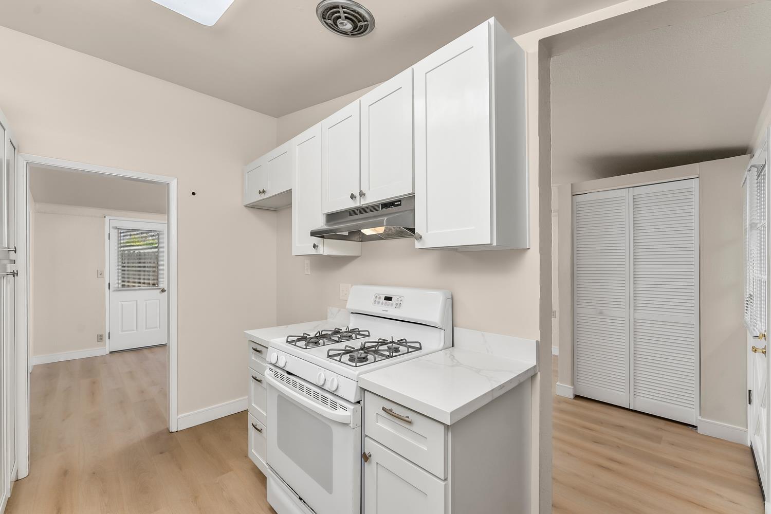 317 Brookwood Road Roseville, CA 95678 - Photo 12 of 36 a kitchen with stainless steel appliances a white stove top oven and a white cabinets