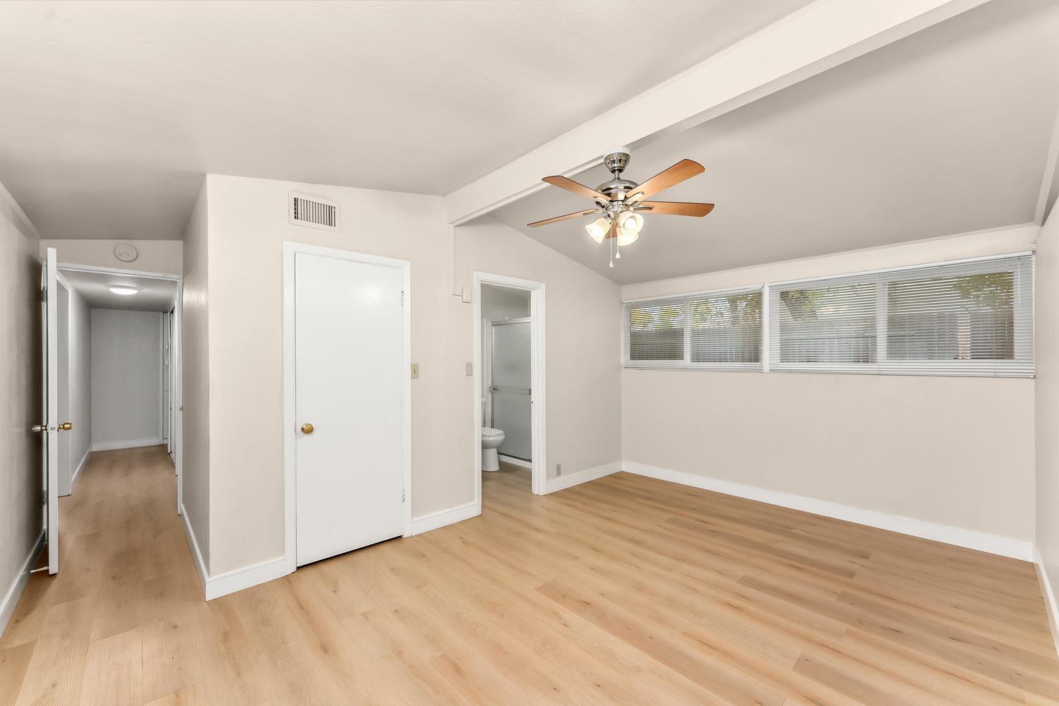 317 Brookwood Road Roseville, CA 95678 - Photo 16 of 36 a view of an empty room with wooden floor and a window