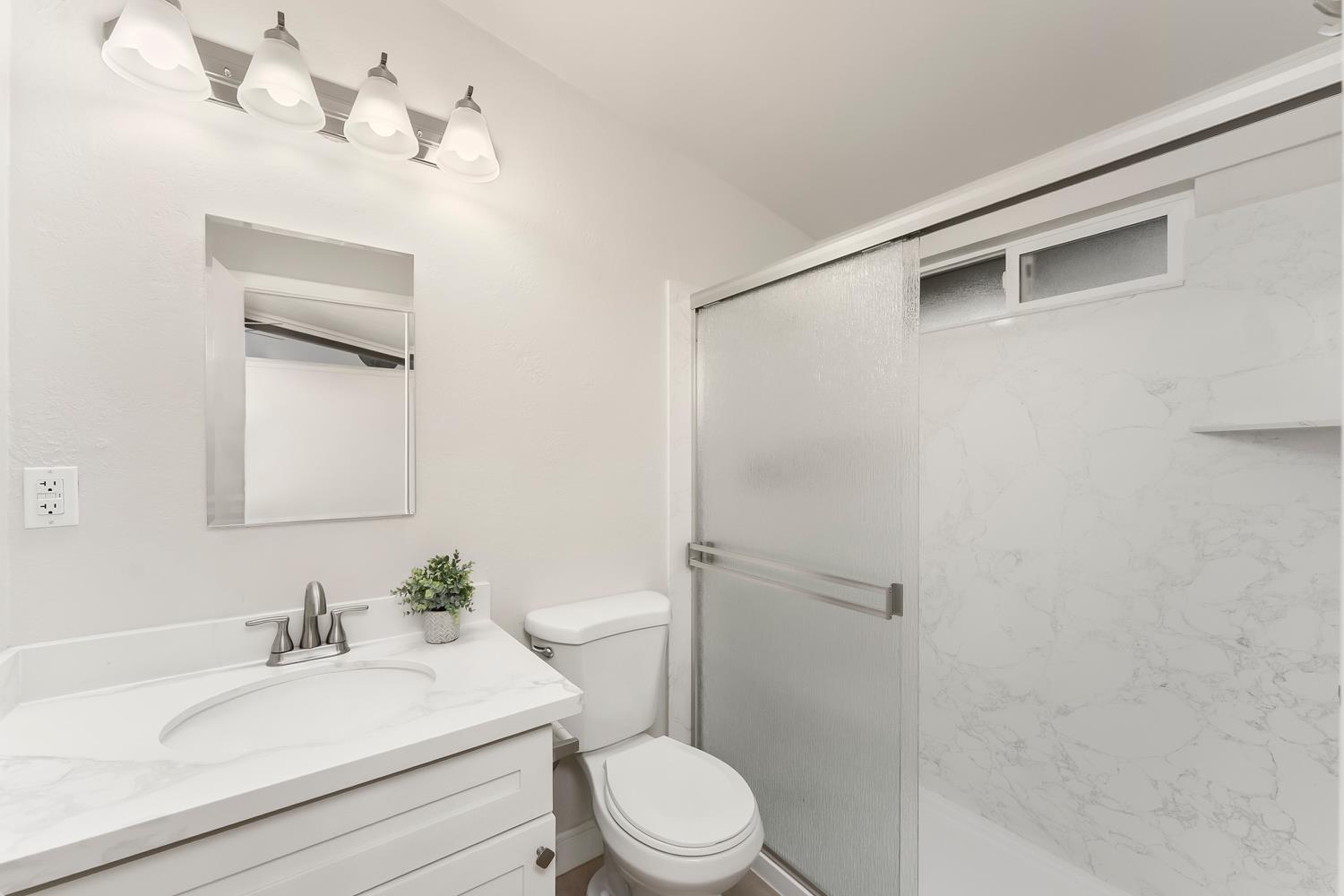 317 Brookwood Road Roseville, CA 95678 - Photo 19 of 36 a bathroom with a sink a toilet and mirror