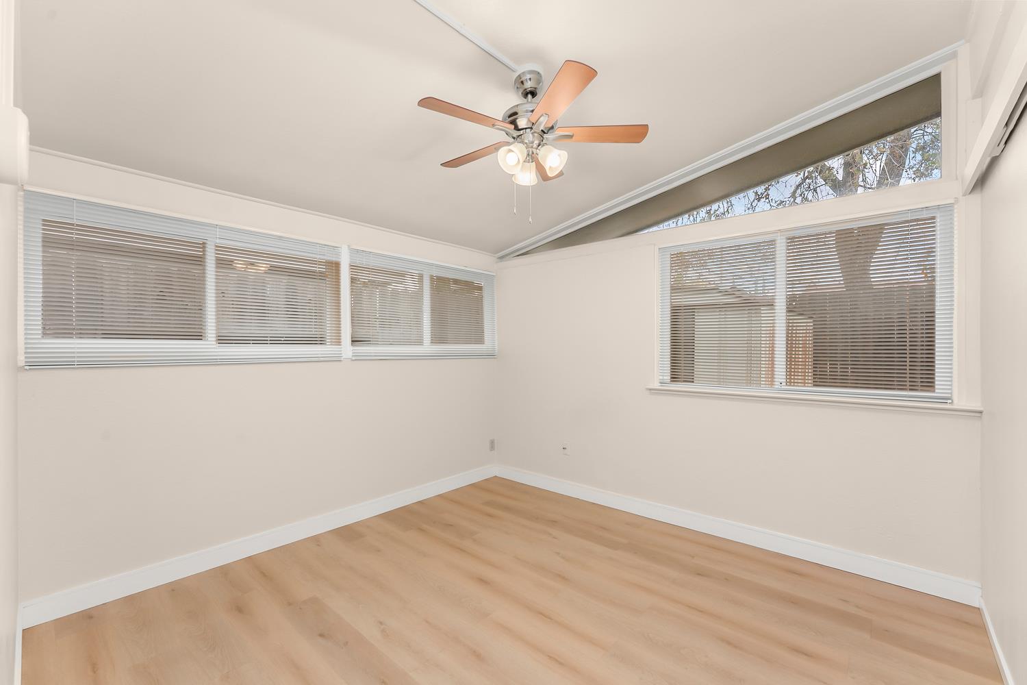 317 Brookwood Road Roseville, CA 95678 - Photo 21 of 36 a view of an empty room with wooden floor and a ceiling fan