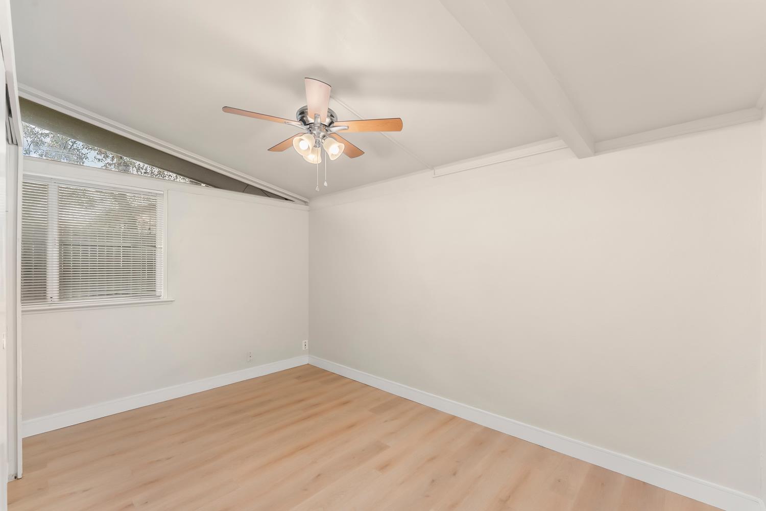 317 Brookwood Road Roseville, CA 95678 - Photo 23 of 36 an empty room with a window and a ceiling fan