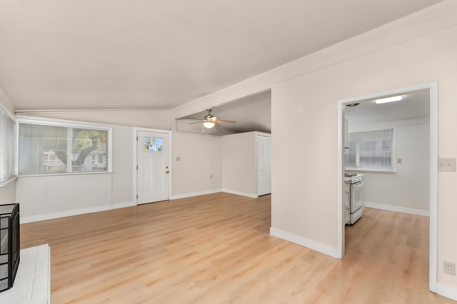 317 Brookwood Road Roseville, CA 95678 - Photo 7 of 36 a view of an empty room with wooden floor and a window