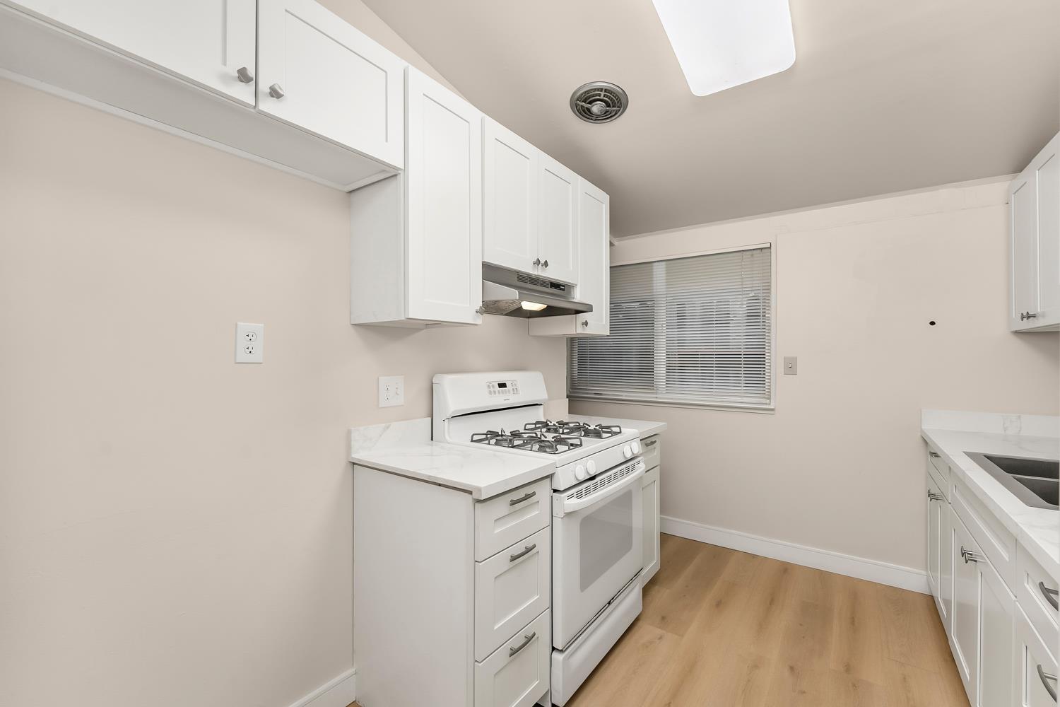 317 Brookwood Road Roseville, CA 95678 - Photo 9 of 36 a kitchen with white cabinets and white appliances