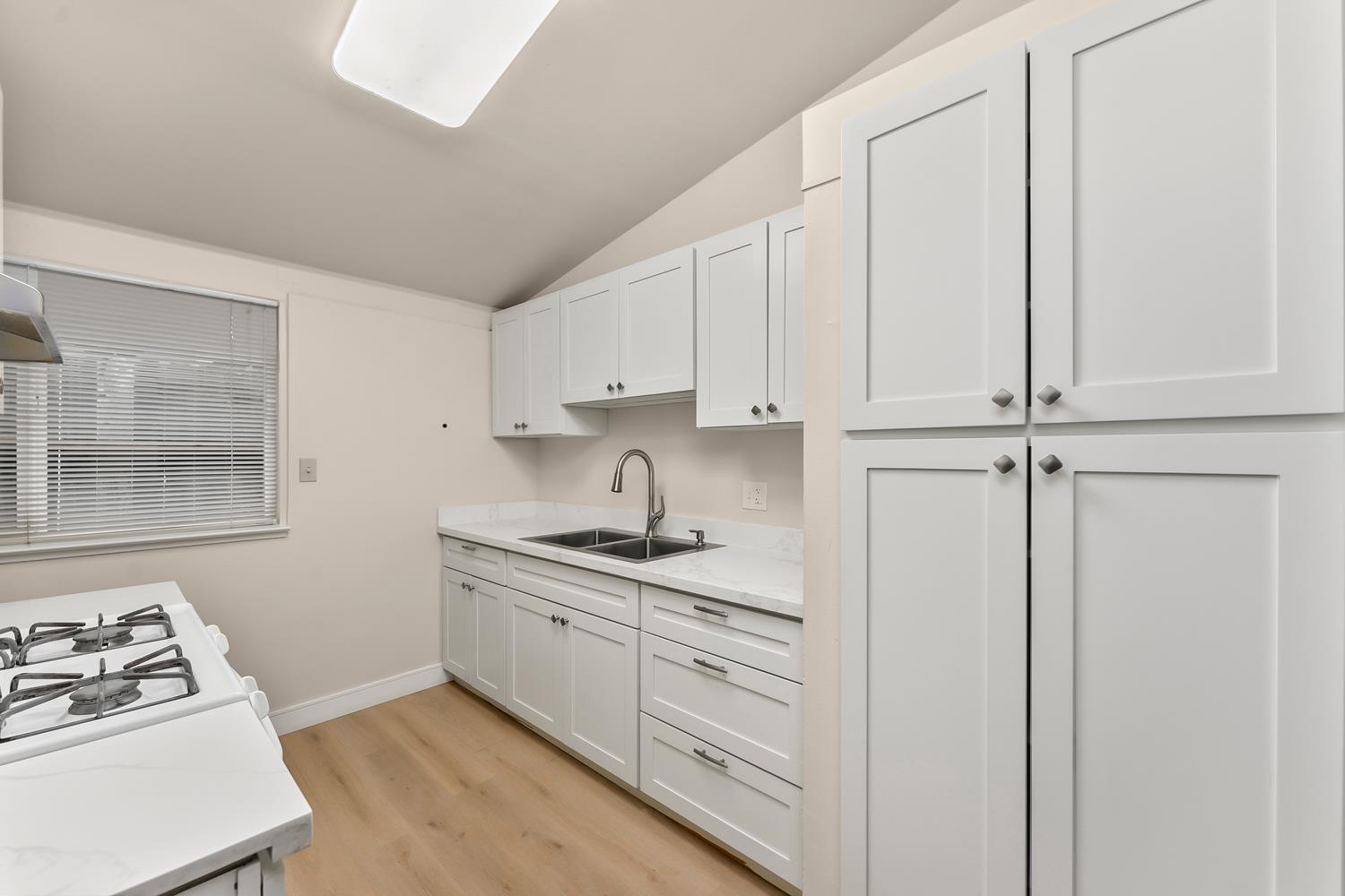 317 Brookwood Road Roseville, CA 95678 - Photo 10 of 36 a kitchen with white cabinets and white appliances