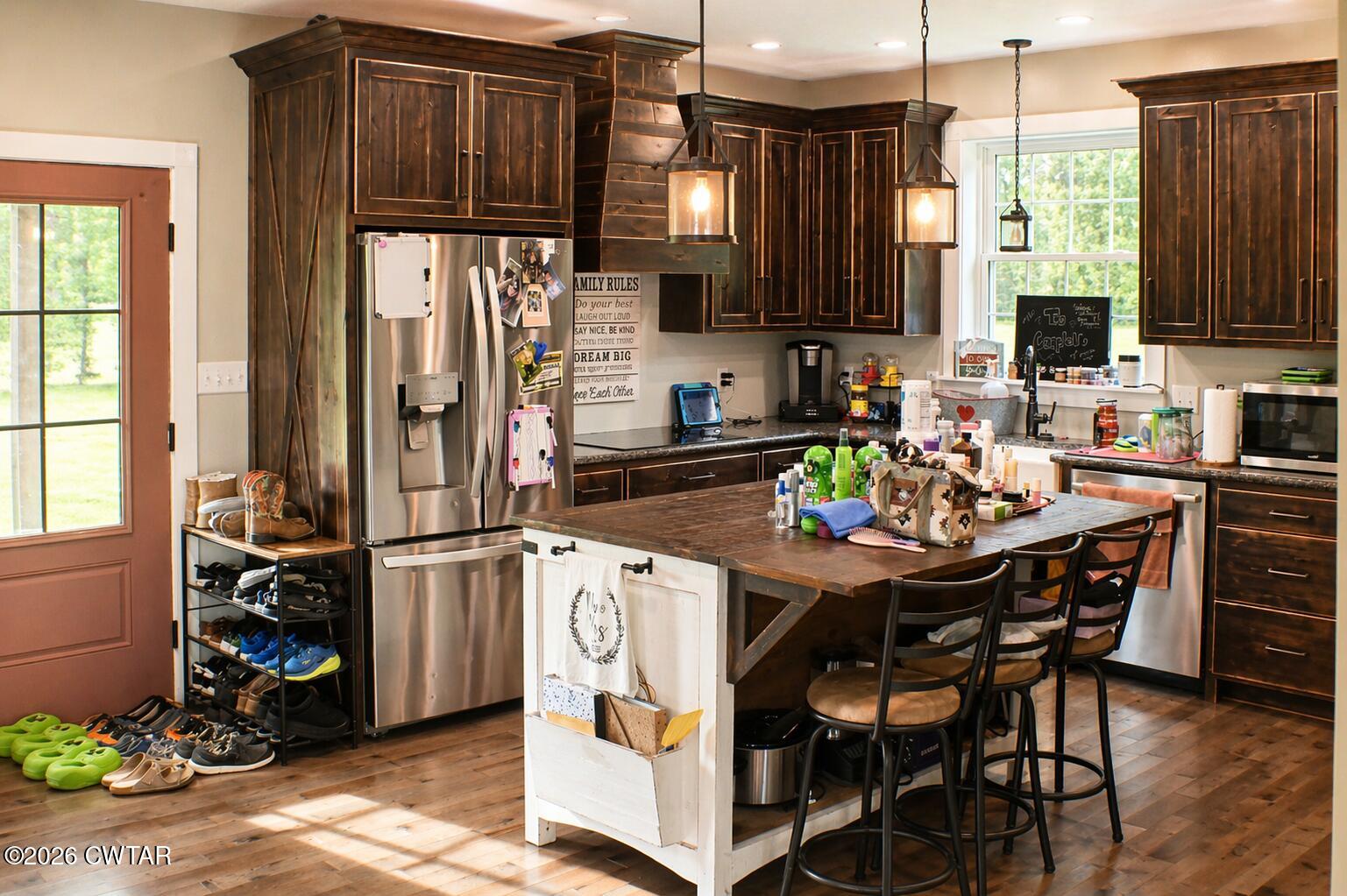 648 Old Dyersburg Road Dyer, TN 38330 - Photo 6 of 20 a kitchen with stainless steel appliances kitchen island granite countertop a table chairs microwave and sink