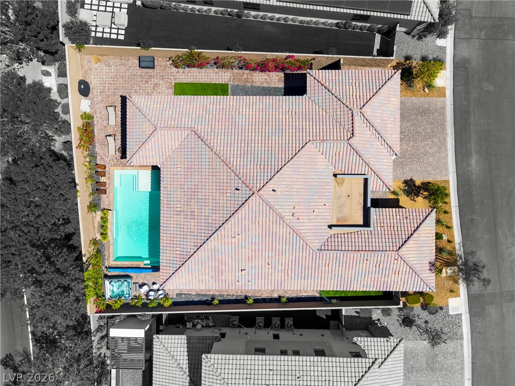 45 Garibaldi Way Henderson, NV 89011 - Photo 47 of 74 An aerial perspective reveals the expansive tile roof, inviting pool, and private spa.