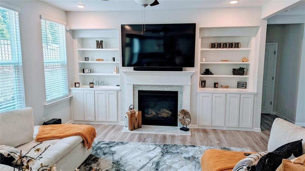 4830 Spangle Court Cumming, GA 30028 - Photo 6 of 18 a living room with furniture and a fireplace