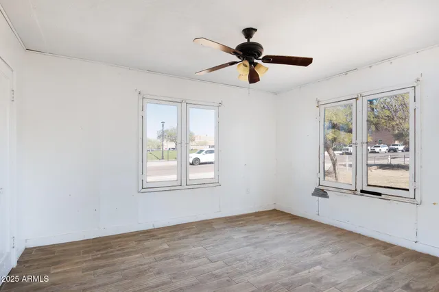 a view of a room with a ceiling fan