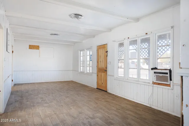 a kitchen with white cabinets and appliances