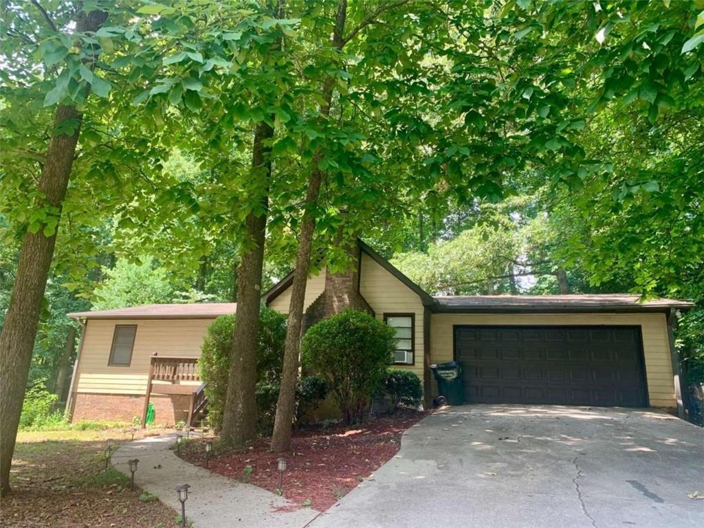 4081 Wrexham Drive Southwest Snellville, GA 30039 - Photo 1 of 1 a house with a tree in front of it