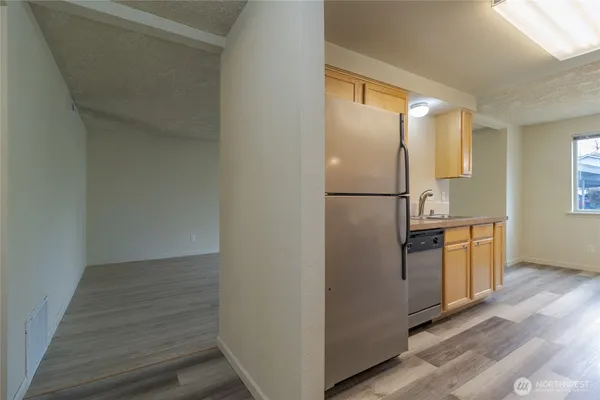 a kitchen with cabinets and stainless steel appliances