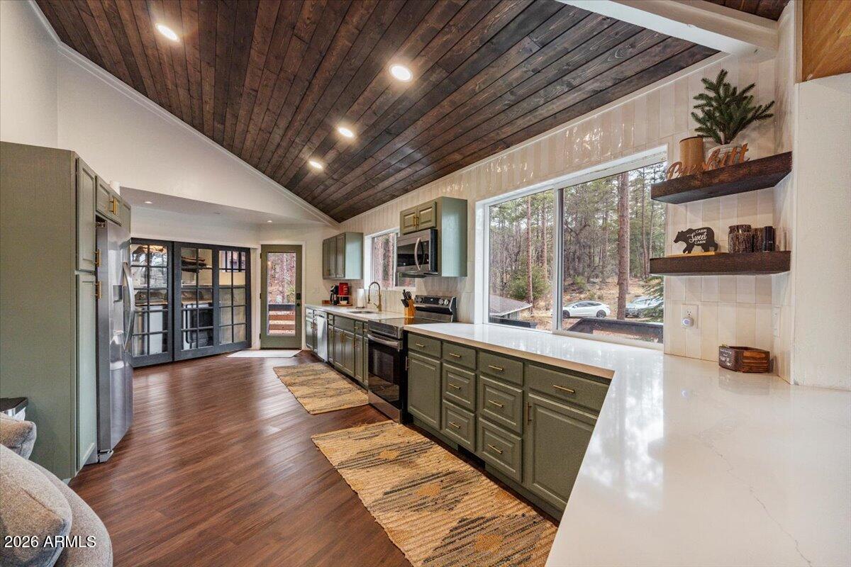 5979 Dearing Road Prescott, AZ 86305 - Photo 21 of 48 a large white kitchen with wooden floor and stainless steel appliances
