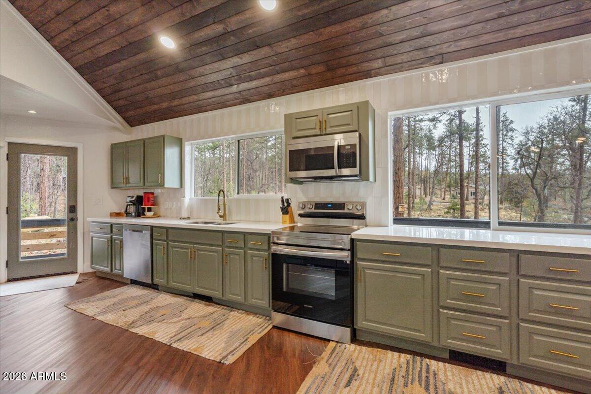 5979 Dearing Road Prescott, AZ 86305 - Photo 26 of 48 a kitchen with granite countertop a stove sink and microwave
