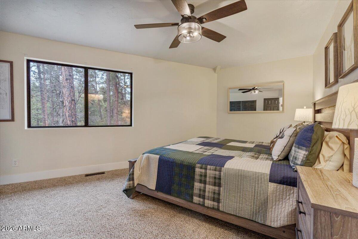 5979 Dearing Road Prescott, AZ 86305 - Photo 36 of 48 a bed sitting in a bedroom next to a window