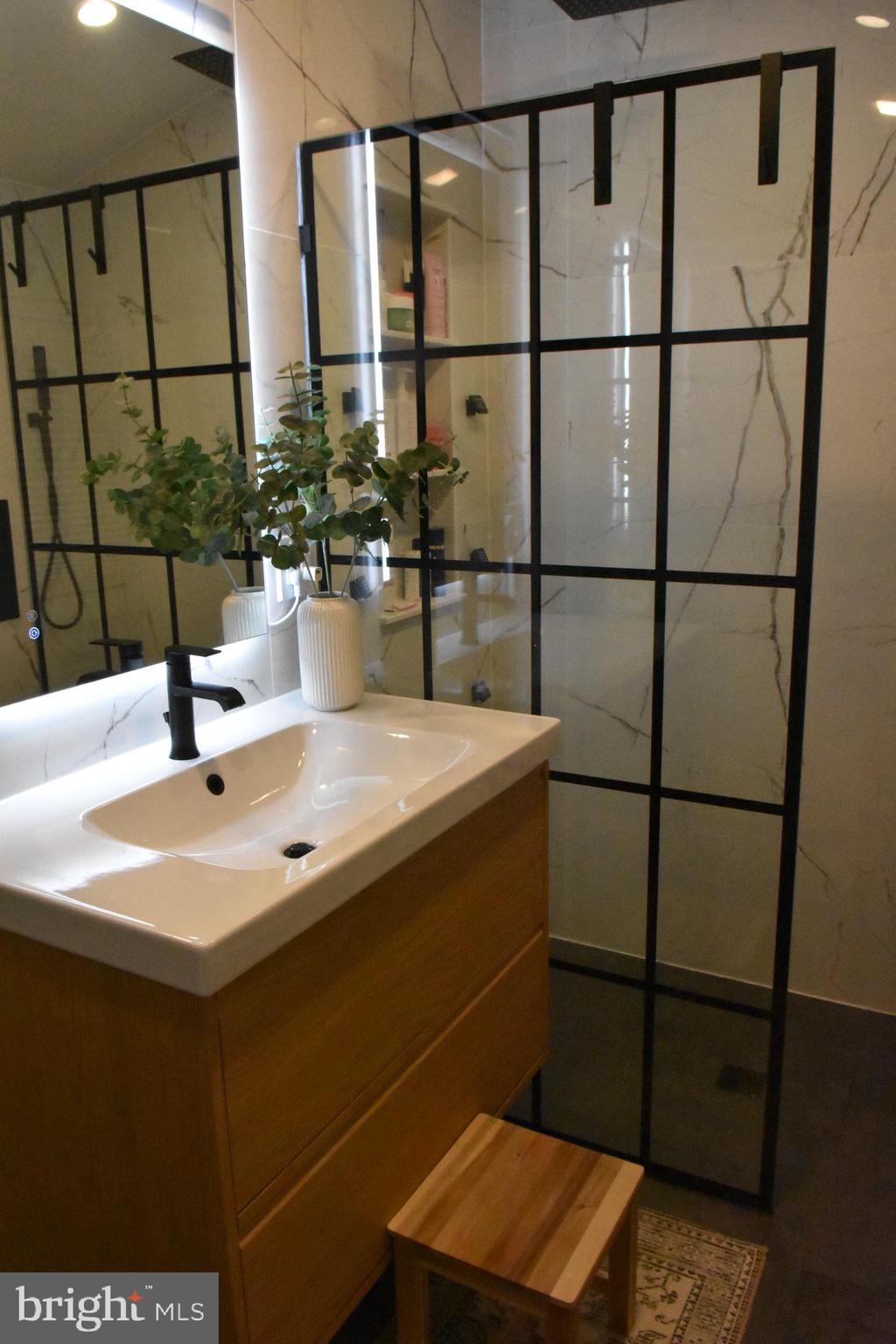 28 Delaware Avenue Ewing, NJ 08628 - Photo 19 of 46 a bathroom with a sink and a mirror