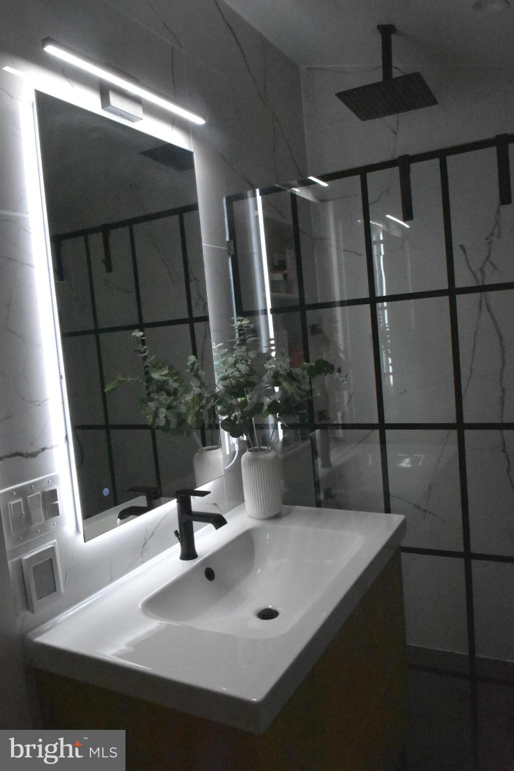 28 Delaware Avenue Ewing, NJ 08628 - Photo 3 of 46 a bathroom with a sink and a mirror
