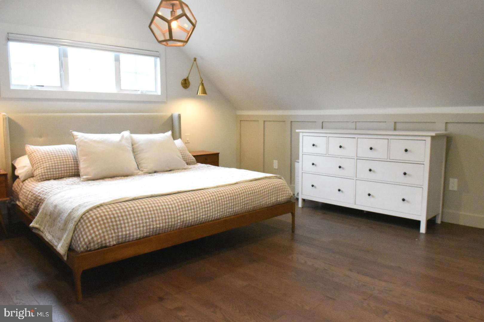 28 Delaware Avenue Ewing, NJ 08628 - Photo 5 of 46 a bedroom with a bed a chandelier and a window