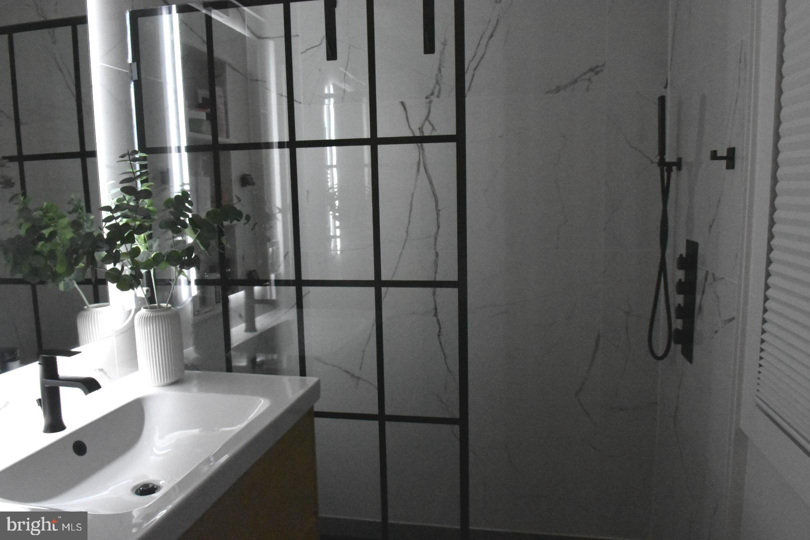 28 Delaware Avenue Ewing, NJ 08628 - Photo 7 of 46 a bathroom with a sink and mirror