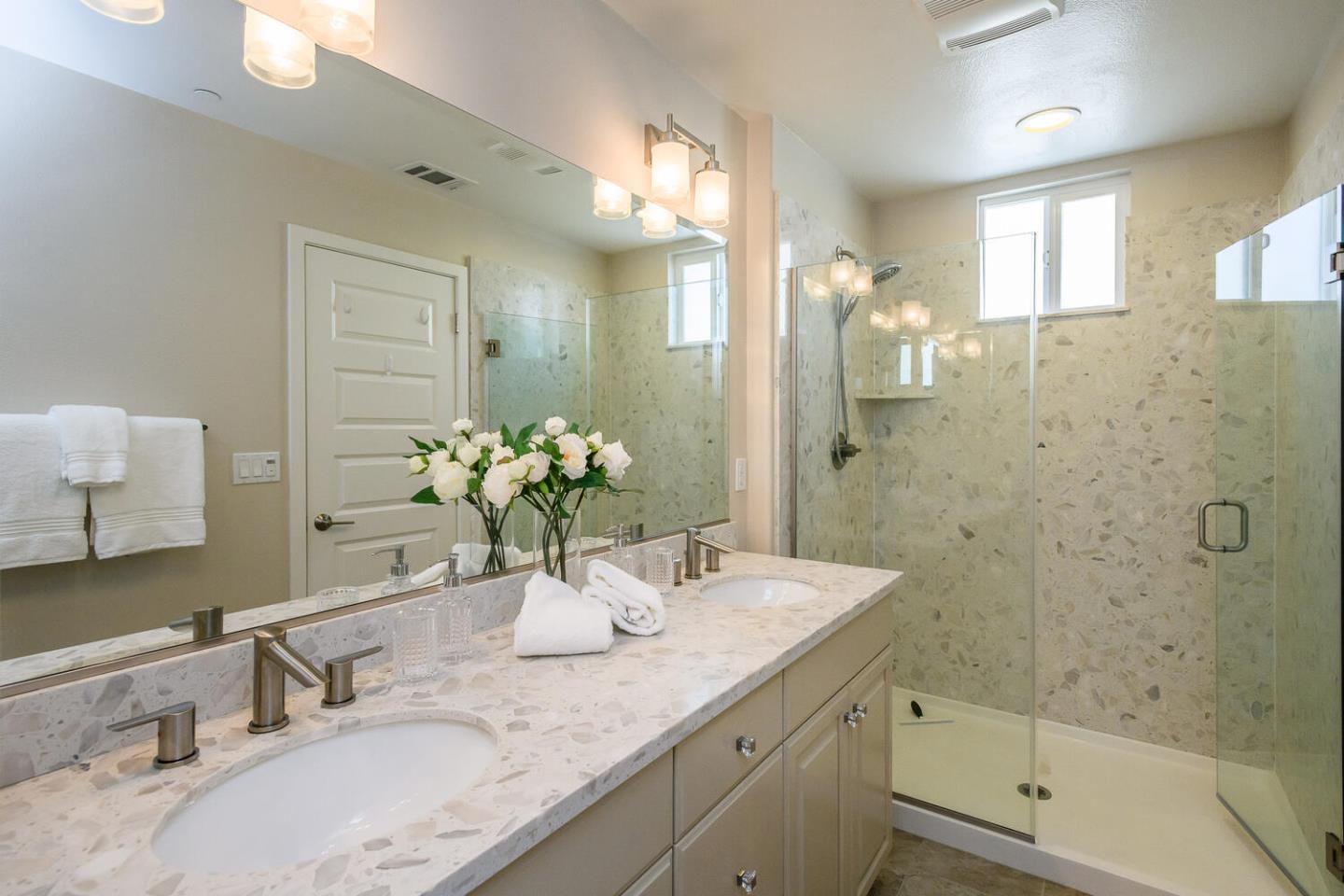 432 Landeros Drive San Mateo, CA 94403 - Photo 13 of 26 a bathroom with a granite countertop sink a mirror and a shower