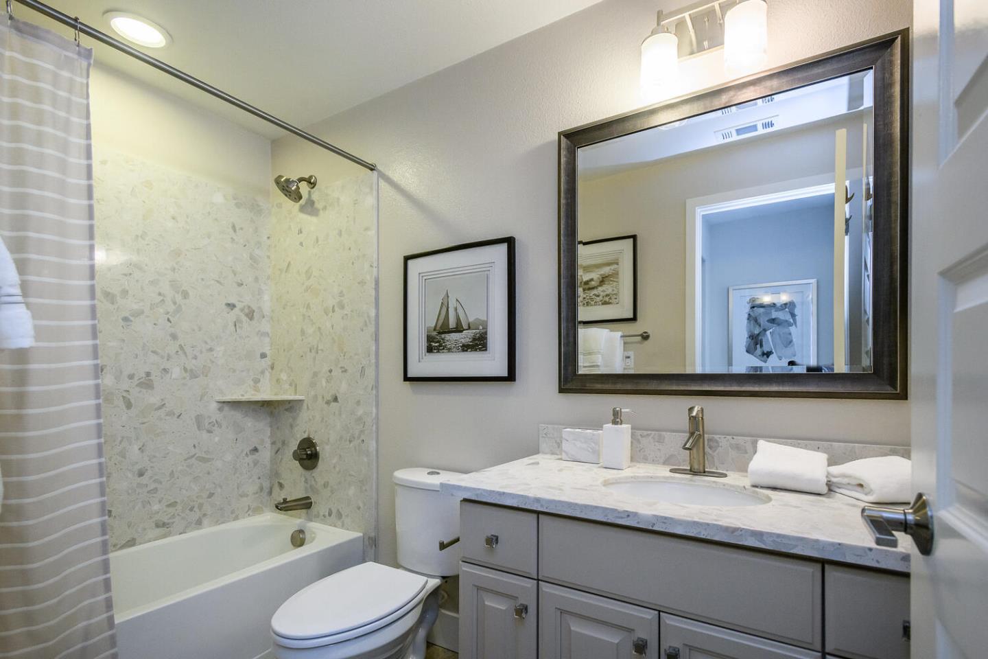 432 Landeros Drive San Mateo, CA 94403 - Photo 15 of 26 a bathroom with a granite countertop sink vanity mirror bathtub shower
