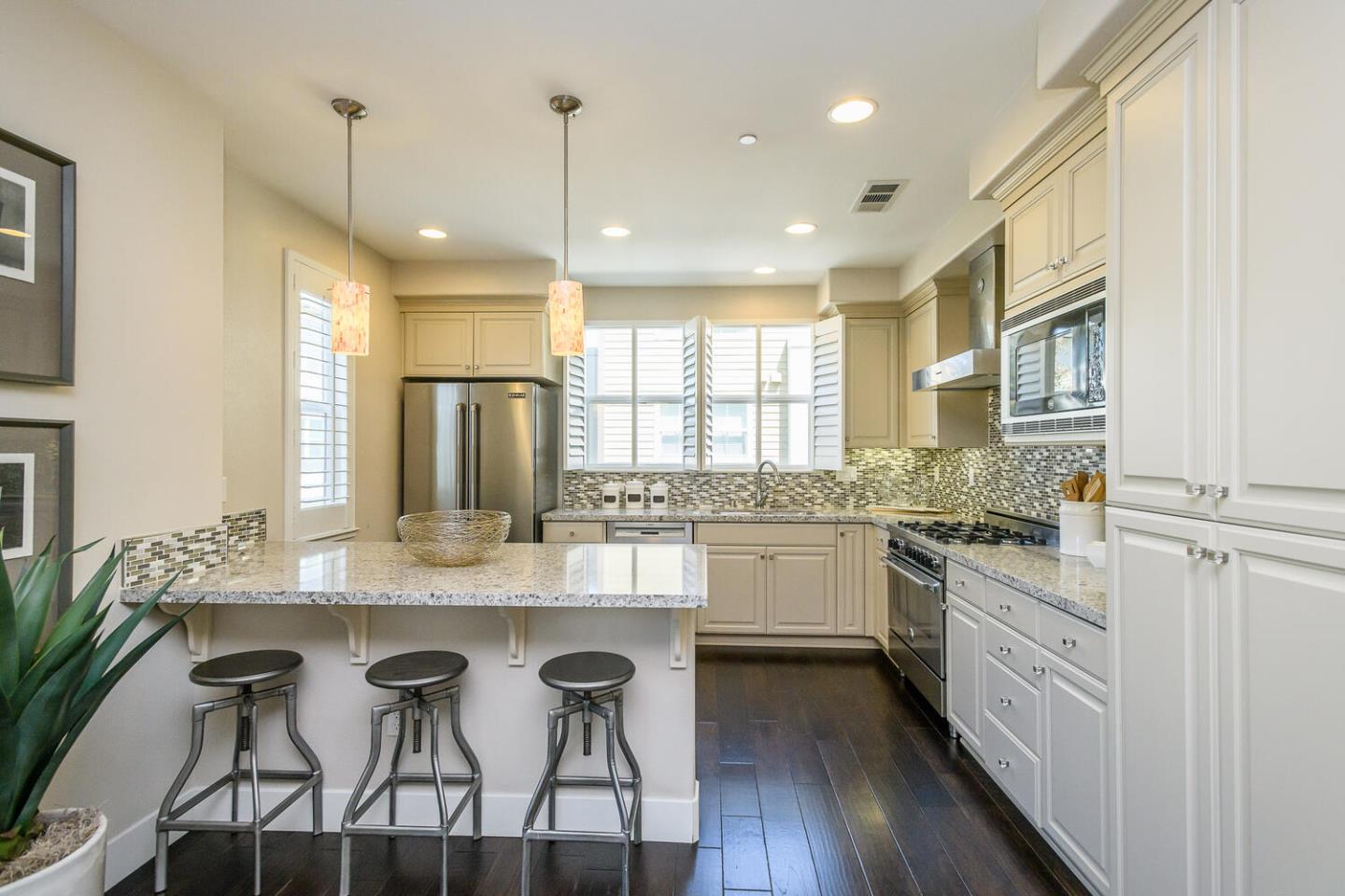 432 Landeros Drive San Mateo, CA 94403 - Photo 7 of 26 a kitchen with granite countertop white cabinets and stainless steel appliances