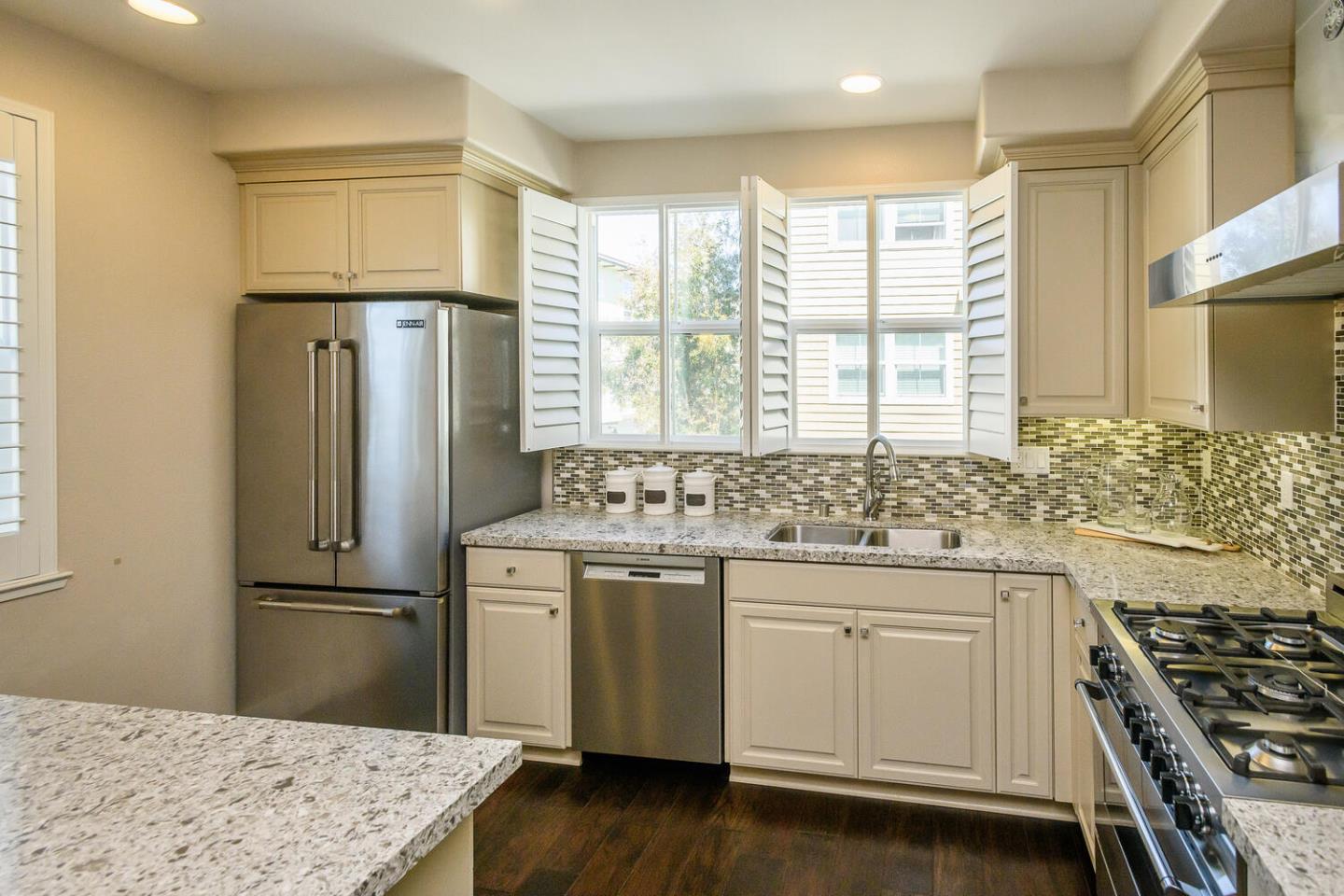 432 Landeros Drive San Mateo, CA 94403 - Photo 8 of 26 a kitchen with stainless steel appliances granite countertop a sink stove and refrigerator