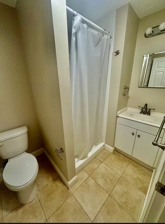 75 Bowers Street, Unit 4 Lowell, MA 01854 - Photo 3 of 5 a bathroom with a sink and a mirror