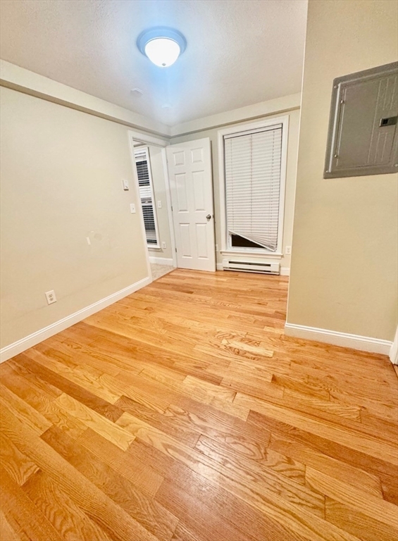 75 Bowers Street, Unit 4 Lowell, MA 01854 - Photo 4 of 5 a view of an empty room with wooden floor