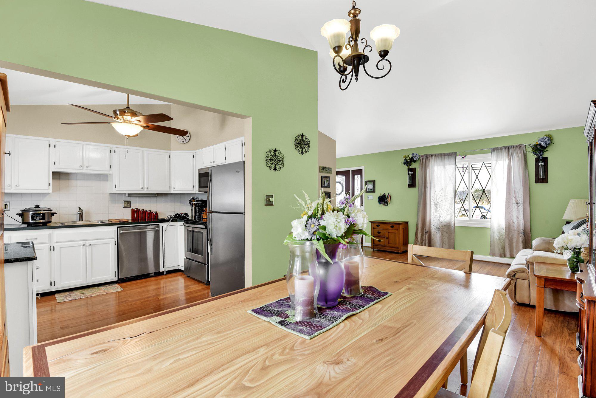 806 Uniontown Road Westminster, MD 21158 - Photo 4 of 10 a kitchen with kitchen island stainless steel appliances sink dining table and chairs