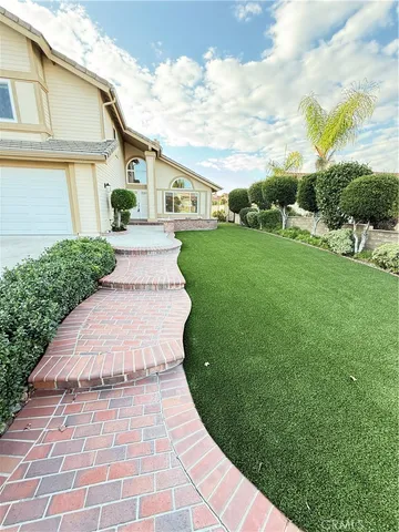 a view of a white house with a yard